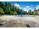 A fun splashpad area and lounge chairs at this community pool at 8818 Artesa Mill Ln, Charlotte, NC 28214