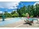 A Gathering-friendly community pool with ample lounge seating and shaded tables at 8818 Artesa Mill Ln, Charlotte, NC 28214