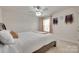 Bedroom featuring a bed and window with decorative curtains and display shelves at 1033 Dorsey Dr, Fort Mill, SC 29715