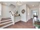 Elegant foyer featuring hardwood floors, a decorative mirror, a modern chandelier, and access to the living areas at 1033 Dorsey Dr, Fort Mill, SC 29715