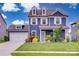 Inviting home with blue siding, white trim, dormer windows, and a well-manicured lawn enhancing the curb appeal at 1033 Dorsey Dr, Fort Mill, SC 29715