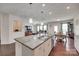 Open concept kitchen with stainless appliances, a large island, and view into the dining and living areas at 1033 Dorsey Dr, Fort Mill, SC 29715