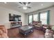 Cozy living room features modern fireplace, flat screen TV, ceiling fan, and reclining couches at 1033 Dorsey Dr, Fort Mill, SC 29715