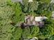 Aerial view of the secluded home surrounded by lush greenery and beautiful landscaping at 104 Golden Bell Ct, Mooresville, NC 28117