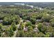 Aerial view of beautiful homes nestled within a dense forest and alongside a tranquil lake at 104 Golden Bell Ct, Mooresville, NC 28117