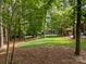 Spacious and well-maintained backyard with lush landscaping and mature trees at 104 Golden Bell Ct, Mooresville, NC 28117