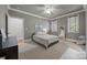Bedroom featuring carpeted floors, large windows, a ceiling fan, and a comfortable bed at 104 Golden Bell Ct, Mooresville, NC 28117