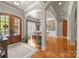 Elegant foyer with hardwood floors, arched doorways, and a view of the dining room at 104 Golden Bell Ct, Mooresville, NC 28117