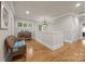 Hallway with hardwood floors and natural light coming through the windows at 104 Golden Bell Ct, Mooresville, NC 28117