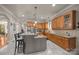 Well-lit kitchen featuring granite countertops, custom cabinetry, and an island with bar seating at 104 Golden Bell Ct, Mooresville, NC 28117