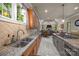 View of the kitchen showcasing stone countertops, tile flooring, and seamless flow into the living area at 104 Golden Bell Ct, Mooresville, NC 28117