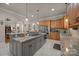 Spacious kitchen features a large island with granite countertops and stainless steel appliances at 104 Golden Bell Ct, Mooresville, NC 28117