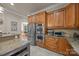 Kitchen featuring stainless steel appliances, granite countertops, and wood cabinetry at 104 Golden Bell Ct, Mooresville, NC 28117
