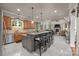 Spacious kitchen with center island, stainless steel appliances, pendant lights and adjoining living room at 104 Golden Bell Ct, Mooresville, NC 28117