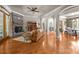 Spacious living room featuring a stone fireplace, hardwood floors, and arched entryways with a cozy aesthetic at 104 Golden Bell Ct, Mooresville, NC 28117