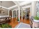 Open-concept living space with hardwood floors, stone fireplace, arched columns, and views of dining and kitchen at 104 Golden Bell Ct, Mooresville, NC 28117