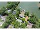 Aerial view of a home with a dock, surrounded by lush trees and lake at 1096 Palmyra Dr, Tega Cay, SC 29708