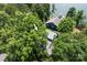 Aerial view of a home with a dock, surrounded by lush trees and lake at 1096 Palmyra Dr, Tega Cay, SC 29708