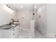 An updated bathroom features a sleek vanity and an elegant walk-in shower with glass doors and custom tile at 1096 Palmyra Dr, Tega Cay, SC 29708