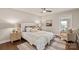 A peaceful bedroom is decorated with an area rug, warm lamps, neutral paint, and soft decor at 1096 Palmyra Dr, Tega Cay, SC 29708