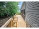 A wooden deck runs alongside the home with wood railings, offering lovely views at 1096 Palmyra Dr, Tega Cay, SC 29708