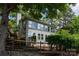 Well-maintained home with plenty of windows, nestled among lush greenery, creating a tranquil curb appeal at 1096 Palmyra Dr, Tega Cay, SC 29708