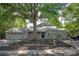 Charming single-story home with stone accents and lush landscaping, featuring a large shade tree in the front yard at 1096 Palmyra Dr, Tega Cay, SC 29708