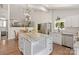 Bright kitchen with stainless steel appliances, a large island with granite countertops, and hardwood floors at 1096 Palmyra Dr, Tega Cay, SC 29708