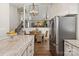 A bright kitchen boasts a granite countertop, stainless steel appliances, and a formal dining area with wicker chairs at 1096 Palmyra Dr, Tega Cay, SC 29708