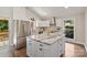 Beautiful kitchen featuring white cabinets, granite countertops, stainless steel appliances, and a large island at 1096 Palmyra Dr, Tega Cay, SC 29708