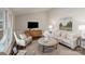 Bright living room featuring a plush sofa, accent chair, modern decor, and plenty of natural light at 1096 Palmyra Dr, Tega Cay, SC 29708