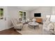 Cozy living room with natural light, stylish furniture, hardwood floors, and a comfortable seating area at 1096 Palmyra Dr, Tega Cay, SC 29708