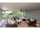 The screened-in porch features stylish furnishings, a ceiling fan, and picturesque views of the water at 1096 Palmyra Dr, Tega Cay, SC 29708