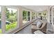 A sunroom provides an indoor/outdoor living space with many windows overlooking the backyard at 1096 Palmyra Dr, Tega Cay, SC 29708