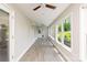 Bright sunroom with large windows, ceiling fans and light neutral walls overlooking lush greenery at 1096 Palmyra Dr, Tega Cay, SC 29708