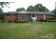 Spacious backyard featuring a screened-in porch and brick exterior at 116 Lanes End Rd, Locust, NC 28097