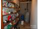 Unfinished basement with shelving, water heater, and exposed utilities at 116 Lanes End Rd, Locust, NC 28097