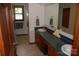 Bathroom featuring double sinks, wooden cabinets, and a large mirror at 116 Lanes End Rd, Locust, NC 28097