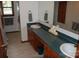 Bathroom featuring double sinks, wooden cabinets, and a large mirror at 116 Lanes End Rd, Locust, NC 28097