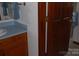 Bathroom features cabinets, sink, mirror, and partial door at 116 Lanes End Rd, Locust, NC 28097