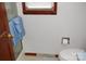 A bright bathroom featuring a white commode and tiled floors at 116 Lanes End Rd, Locust, NC 28097