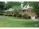 Traditional brick home with a covered front porch and well-manicured landscaping at 116 Lanes End Rd, Locust, NC 28097