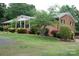 Charming brick home featuring a covered porch, attached garage, and lush green lawn at 116 Lanes End Rd, Locust, NC 28097