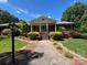 Inviting front entrance with manicured landscaping and charming details, showcasing the home's curb appeal at 116 Lanes End Rd, Locust, NC 28097