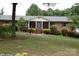 Well-maintained brick home with inviting front porch, brick steps, and mature shrubs at 116 Lanes End Rd, Locust, NC 28097
