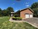 Spacious two-car garage and beautiful yard, ideal for parking and outdoor activities at 116 Lanes End Rd, Locust, NC 28097