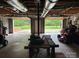 Interior garage view through open garage doors with equipment and tool storage on display at 116 Lanes End Rd, Locust, NC 28097