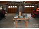 Large garage with 2 bay doors, a workbench and storage space for vehicles at 116 Lanes End Rd, Locust, NC 28097