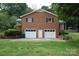 Exterior of brick home featuring two car garage, brick accents, and well maintained yard at 116 Lanes End Rd, Locust, NC 28097
