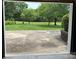 Wide view from inside open garage showcases expansive lawn and mature trees at 116 Lanes End Rd, Locust, NC 28097